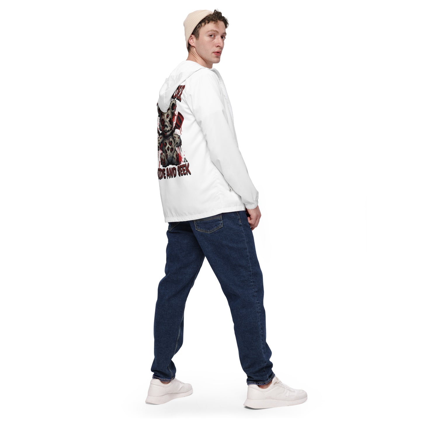 Man wearing a white long-sleeve shirt with graphic design and blue jeans on a white background