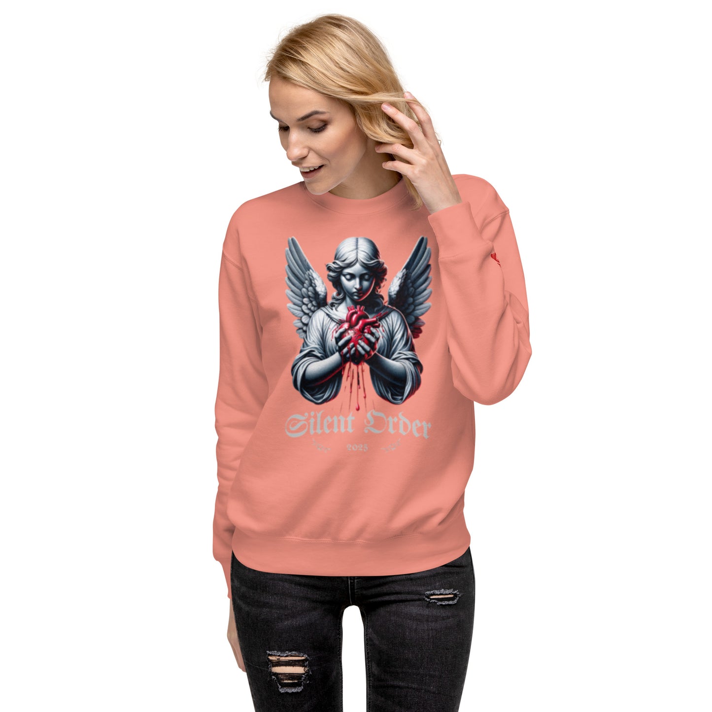 Person wearing a pink sweatshirt with a graphic design on a white background