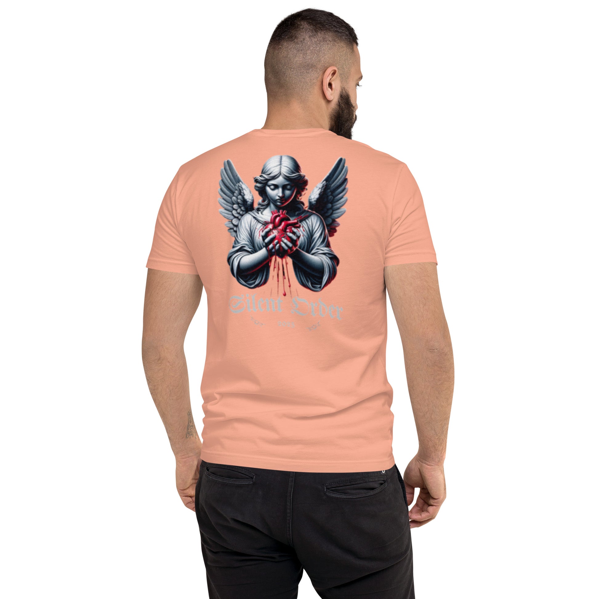Man wearing a peach t-shirt with a graphic design on the back, standing against a white background.