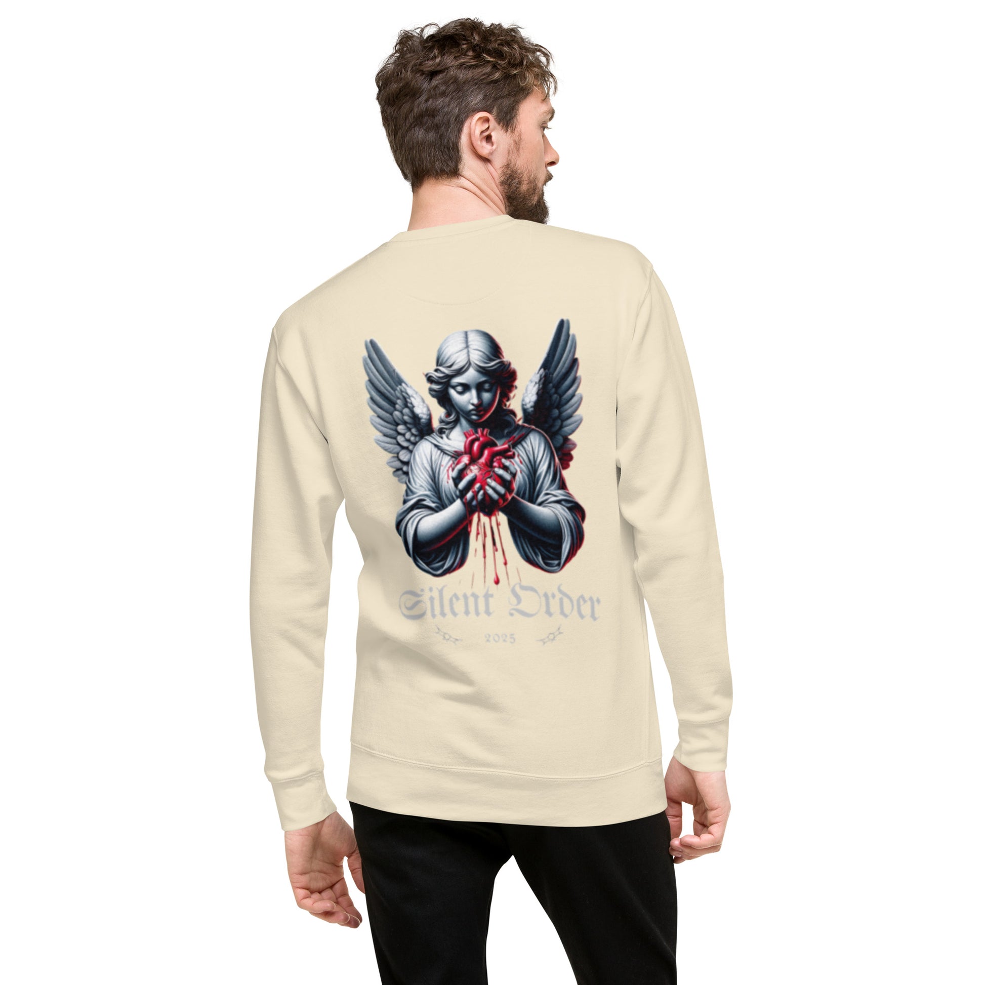 Man wearing a beige long-sleeve shirt with an angel graphic and 'Silent Order' text on the back.