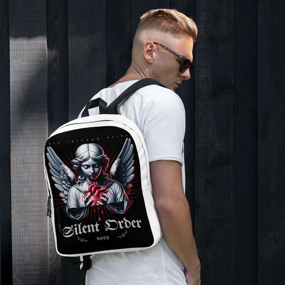 Man wearing a white backpack with an angel design and 'Silent Order' text.