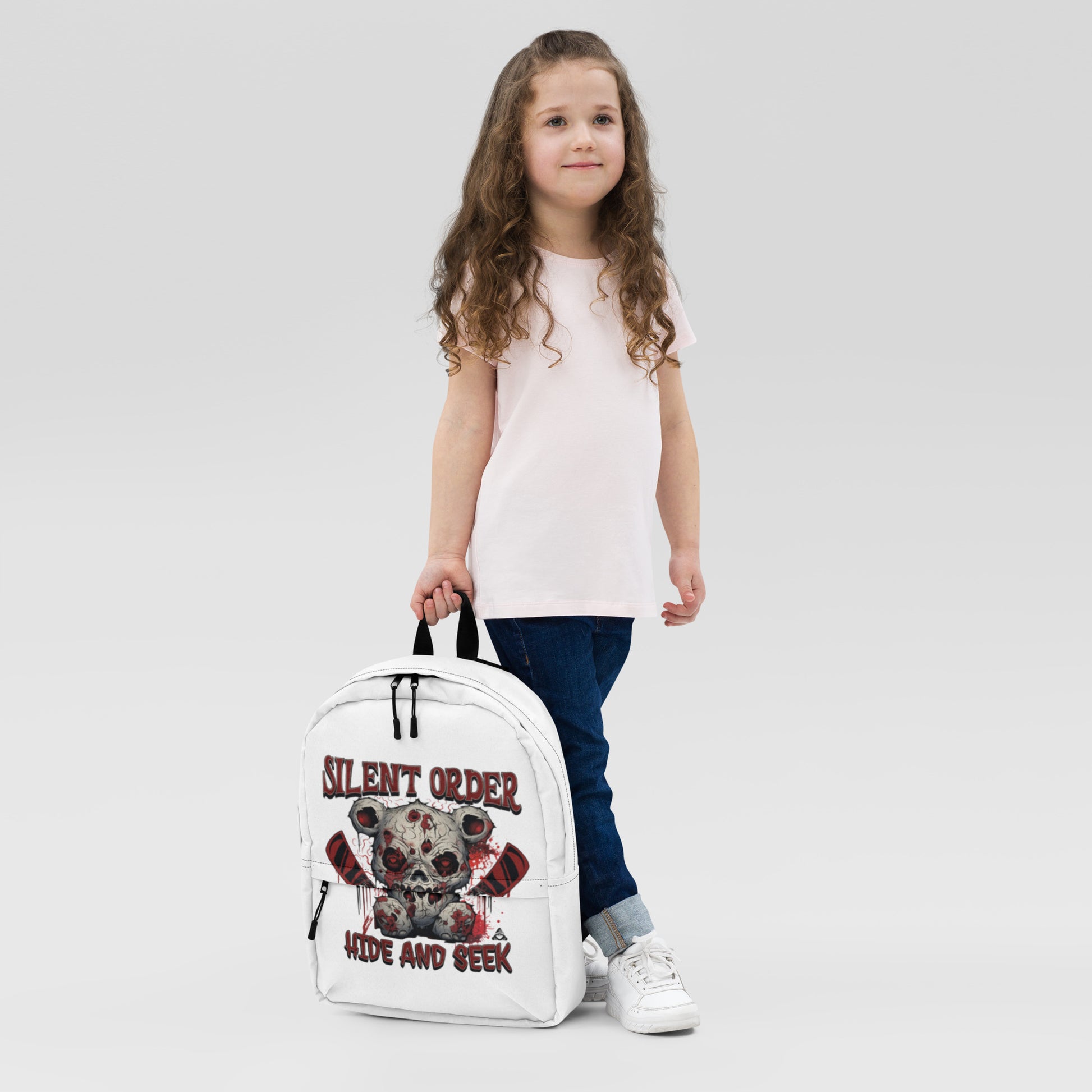 Child holding a white backpack with a design and text on a light gray background