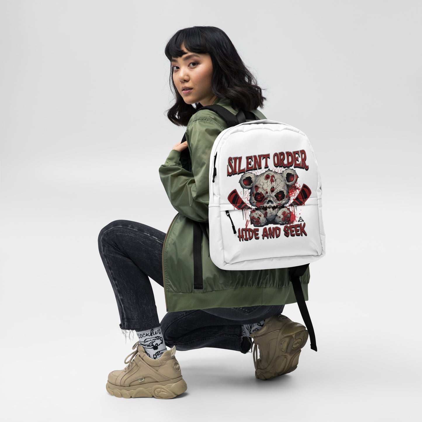 Person wearing a white backpack with 'Silent Order' design on a plain background