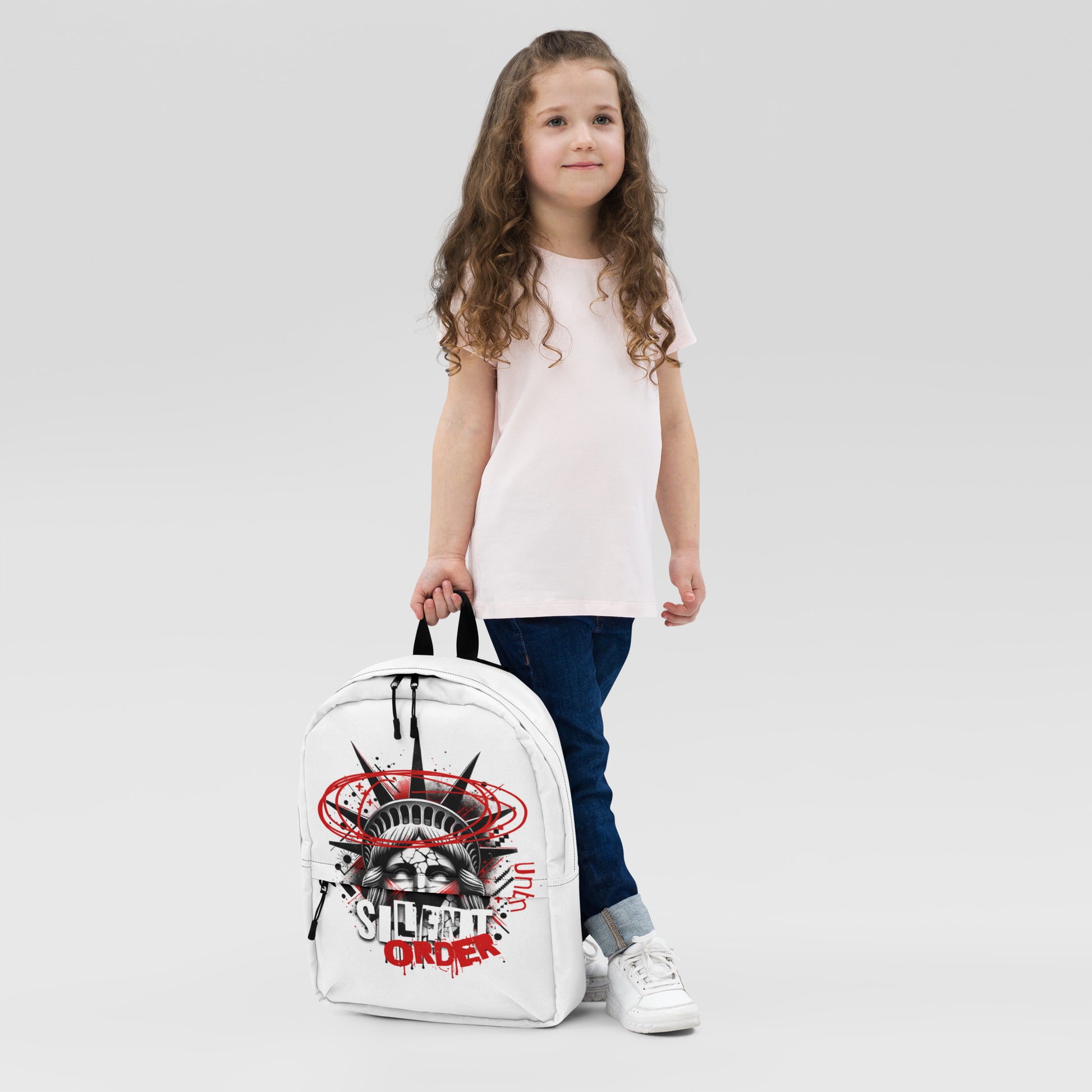 Child holding a white backpack with a graphic design on a light gray background