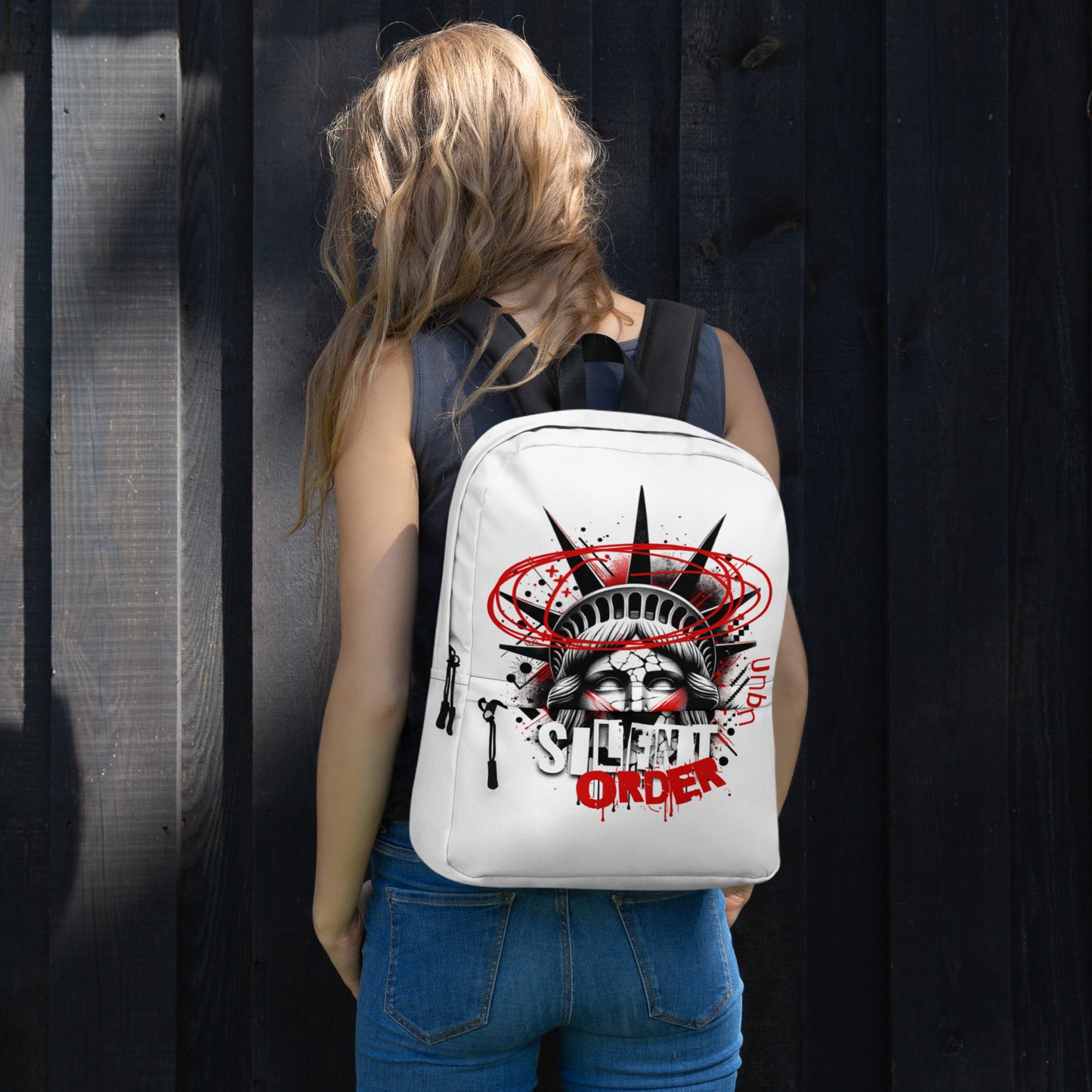 Person wearing a white backpack with a graphic design against a dark background