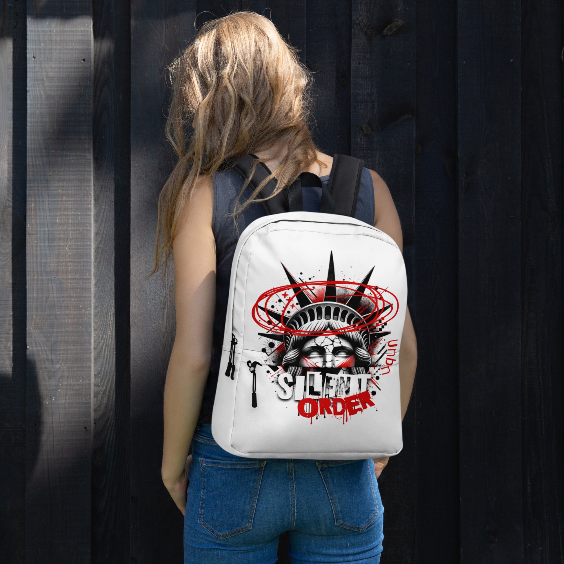 Person wearing a white backpack with a graphic design against a dark background