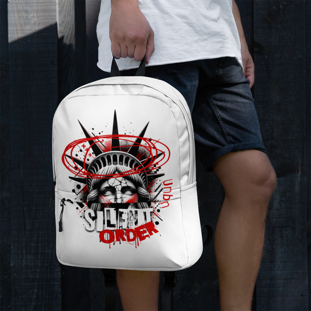 Person holding a white backpack with graphic design and text.