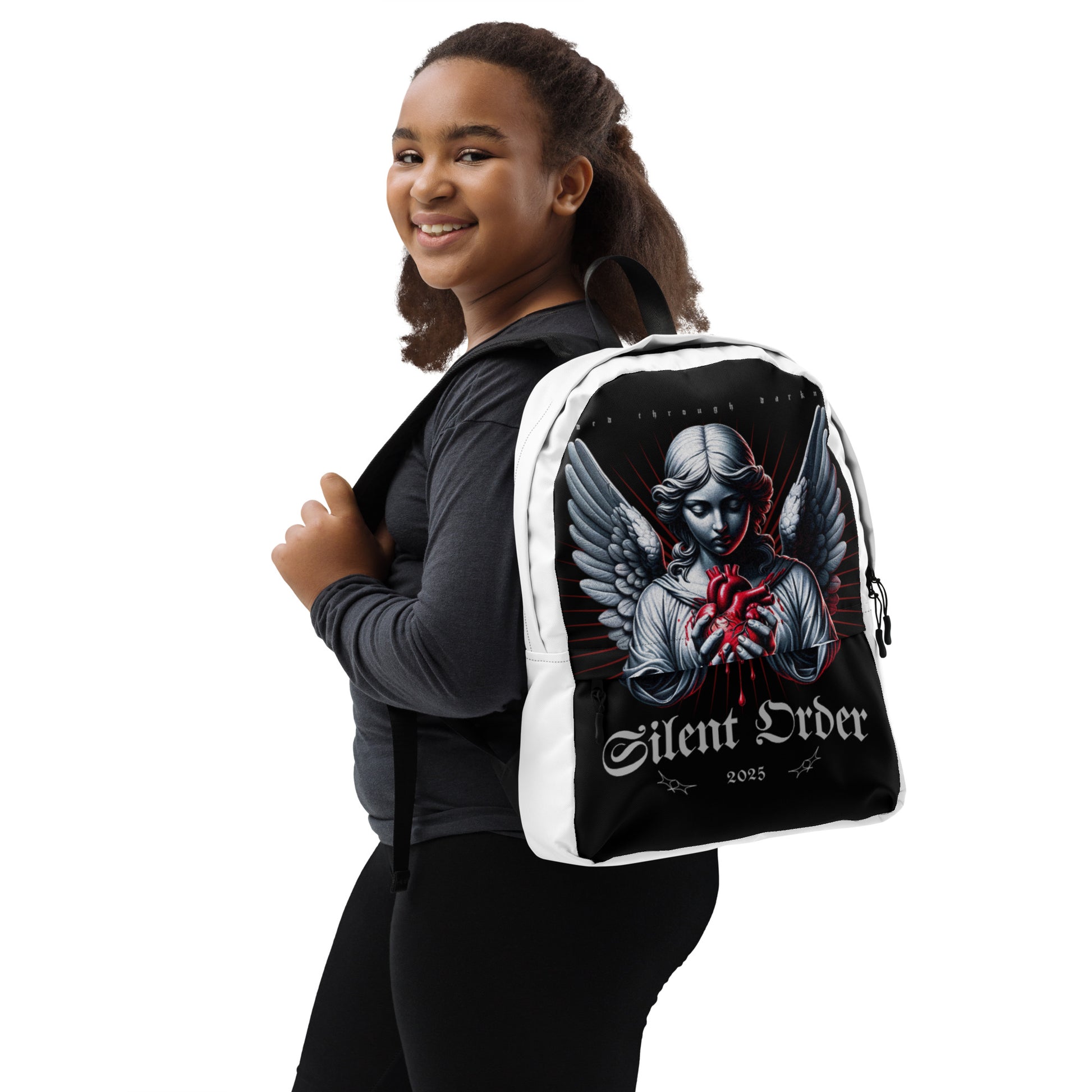 Person wearing a black and white backpack with an angel design and 'Silent Order' text.