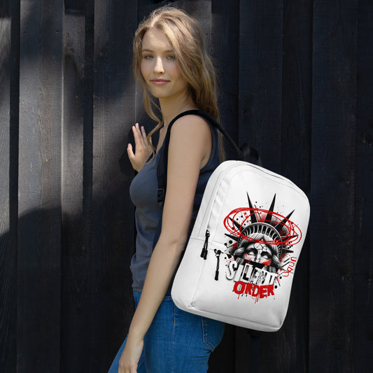 Woman holding a white backpack with a graphic design against a dark background