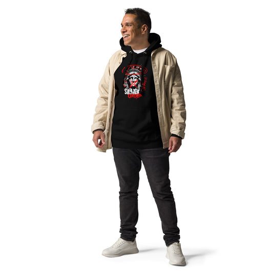 Man wearing a black graphic t-shirt, beige jacket, and dark jeans on a white background