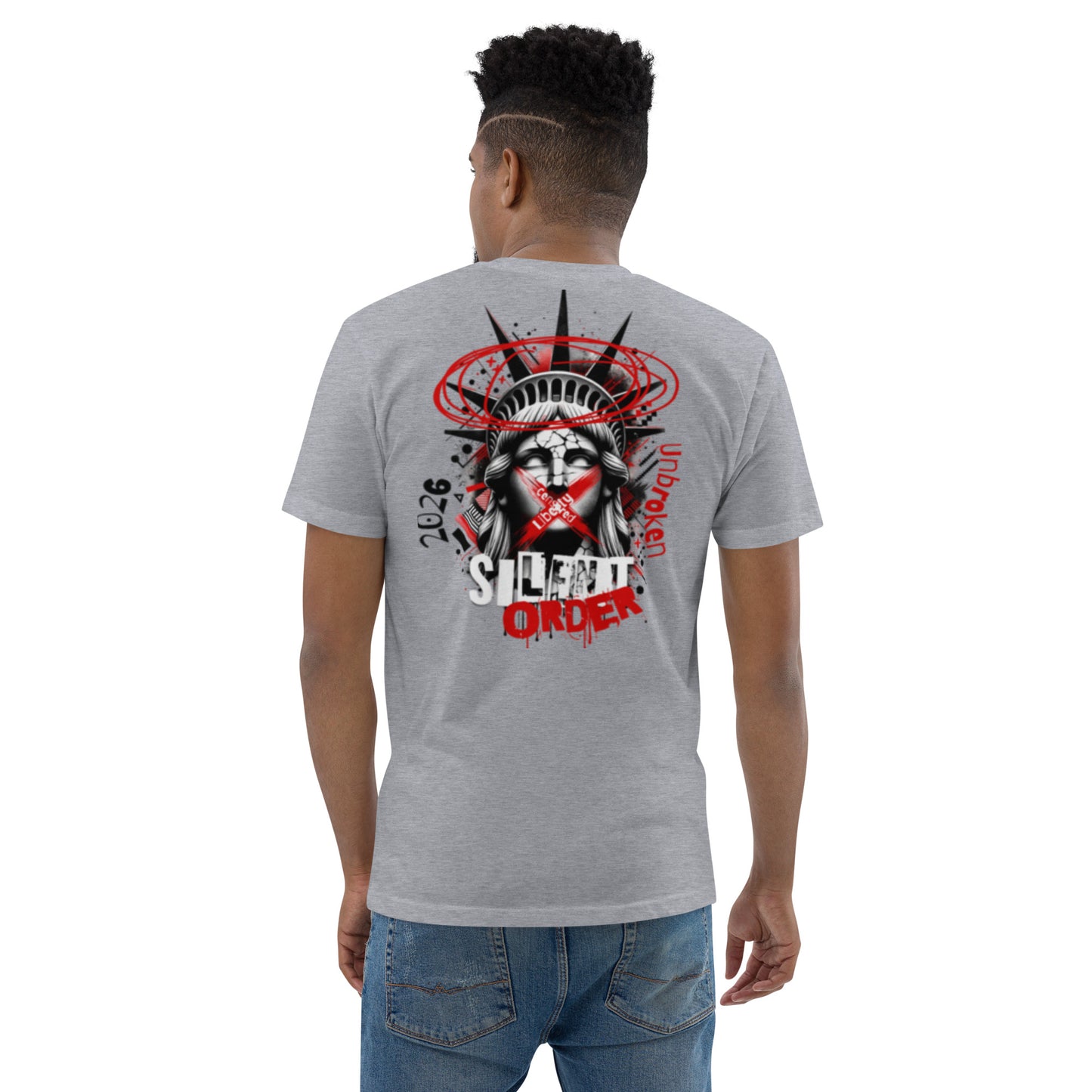 Person wearing a gray t-shirt with a graphic design on the back, standing against a white background