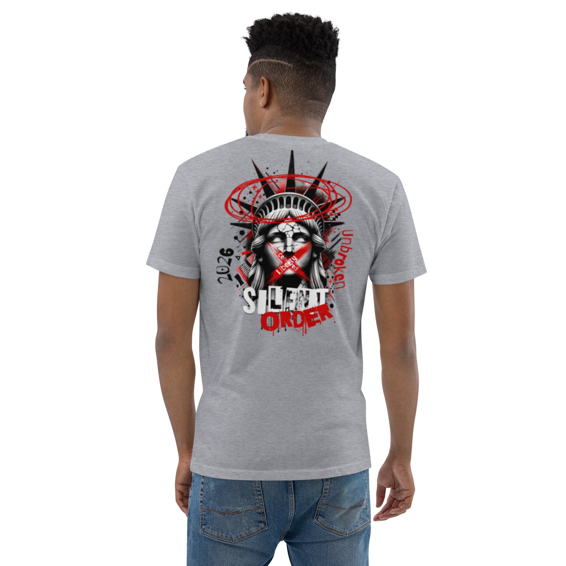 Person wearing a gray t-shirt with a graphic design on the back, standing against a white background