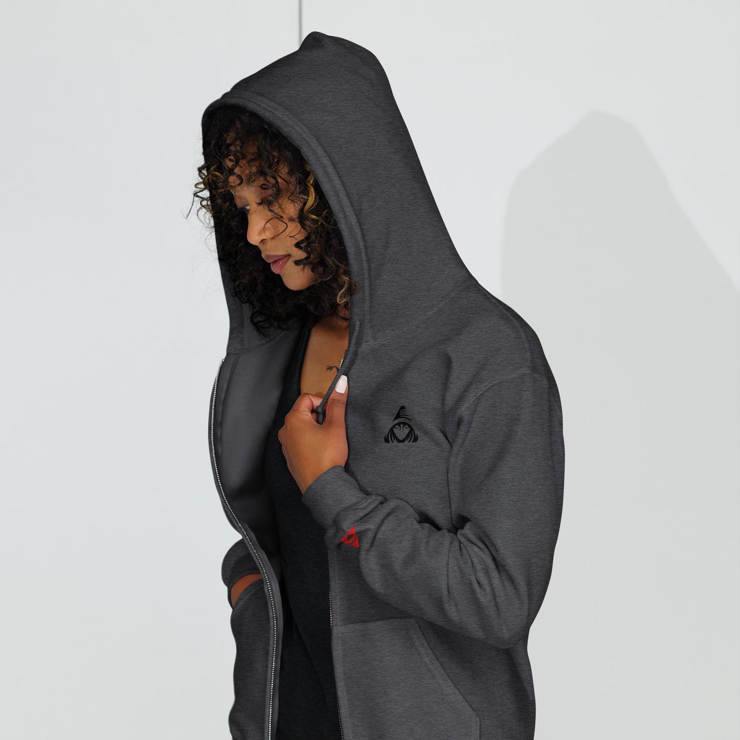 Person wearing a gray hoodie with a logo on a white background