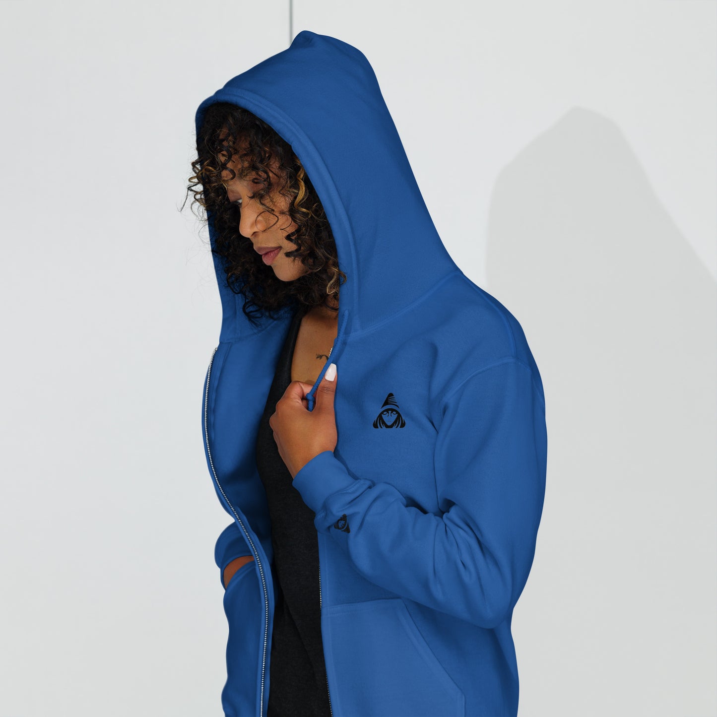 Person wearing a blue hoodie with a logo on a white background