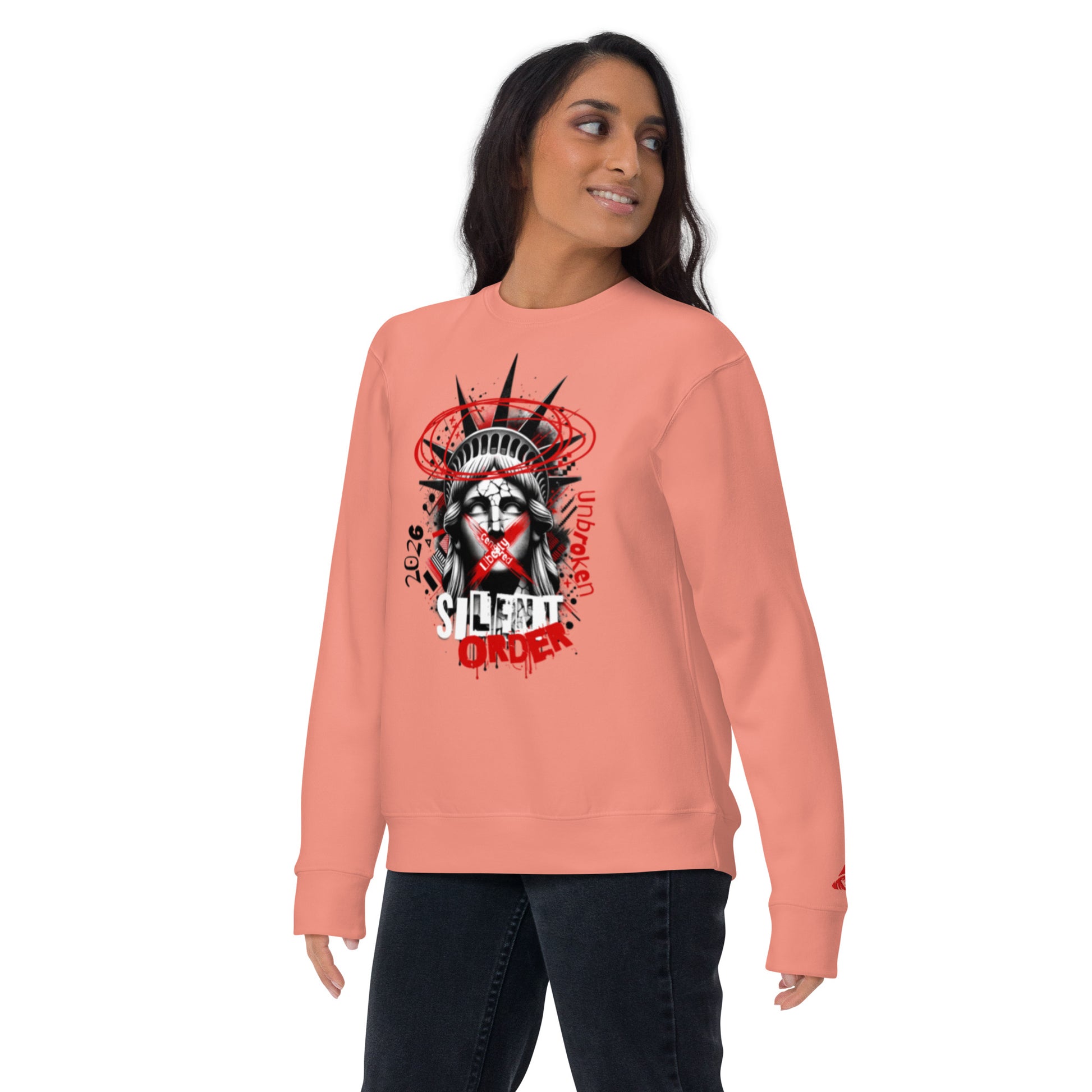 Person wearing a pink sweatshirt with a graphic design on a white background